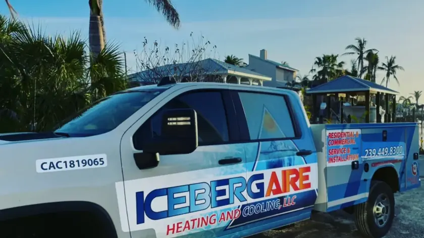 Iceberg Aire technician diagnosing an outdoor AC condenser at a Southwest Florida home